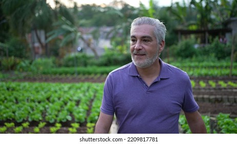 Contemplative Senior Man Walking Outdoors In Small Farm. Pensive Older Person Walks Forward Portrait Face Closeup