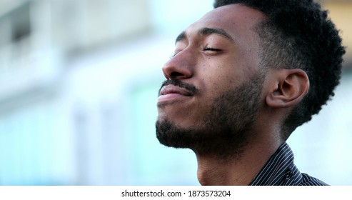 Contemplative young African black man eyes closed in mindful meditation - Shutterstock ID 1873573204