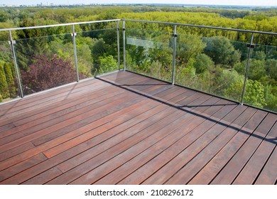 Contemporary architecture appartment balcony view with exotic cumaru wood decking of grooved surface timber and glass railing