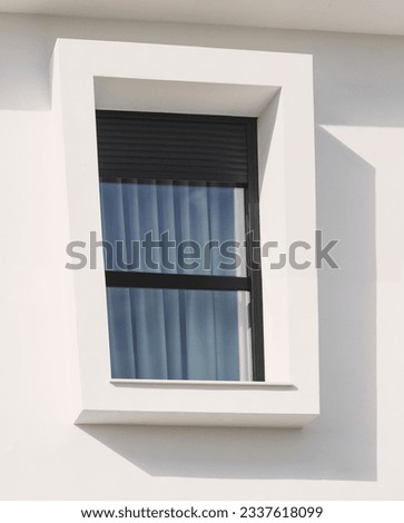 Contemporary architecture. Modernist window on a white wall.