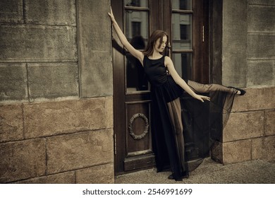 Contemporary Art and Ballet. Full-length portrait of a graceful young ballerina posing in front of an old city building. - Powered by Shutterstock