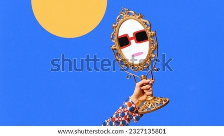 Contemporary art collage with female hand holding small mirror with drawn facial expression over blue background. Doodles, sketches, cartoon drawing style. Human emotions