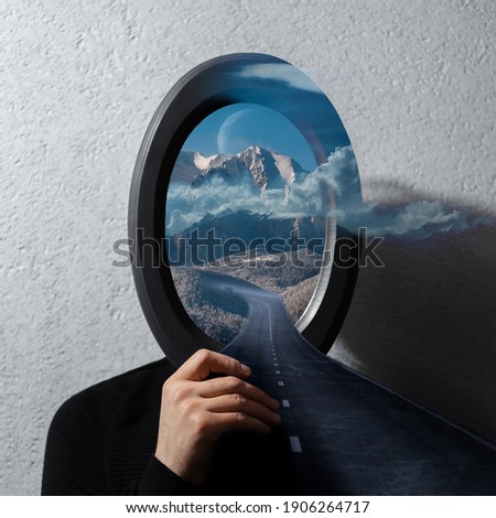 Contemporary artwork collage concept. Man holding black frame on face with beautiful landscape of cloudy mountains and asphalting road.