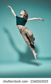 Contemporary Ballet. Modern Ballet Dancer Girl Flies In Jump. Dance Expression. Full-length Studio Portrait.