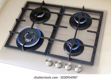 Contemporary built-in gas oven switch on, many hobs with flame, top view 