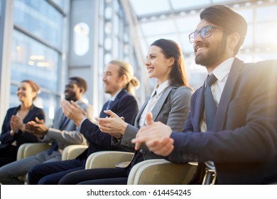 Contemporary Business People Clapping Their Hands At Conference Or Other Corporate Event