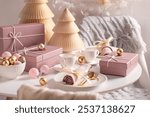 Contemporary Christmas tableware for two surrounded by Christmas decorations. Christmas gift card concept.