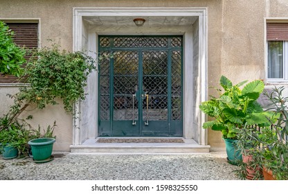 contemporary classic design apartment building front entrance door and potted plants