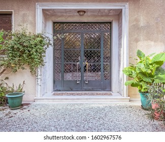 contemporary classic design apartment building front entrance door and potted plants, Athens Greece