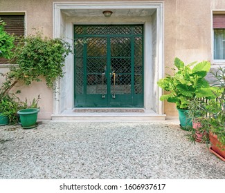 contemporary classic design apartment building front entrance green door and potted plants