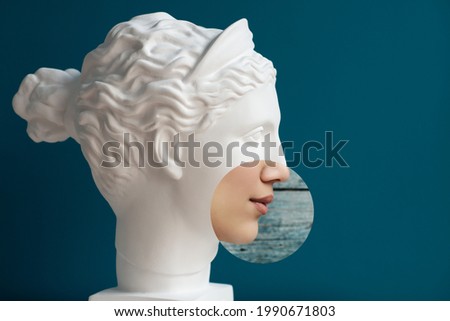 Contemporary collage of plaster statue head and woman in profile over deep blue background. Antiquity and modernity. 