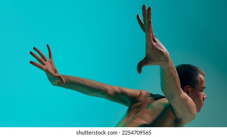 Contemporary dance style. Young artistic man dancing contemp, experimental dance over blue, cyan studio background. Expressive movements. Concept of art, body aesthetics, motion, action, inspiration. - Shutterstock ID 2254709565