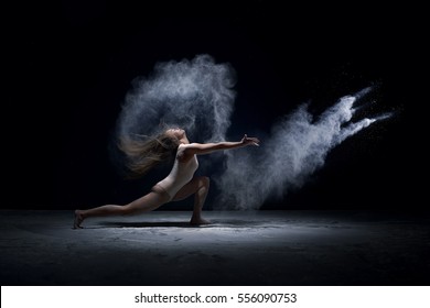 Contemporary dancer performing  in cloud of powder