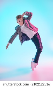 Contemporary Dances. Professional Hip Hop And Break Dancer Boy Dancing At Studio On A White Background In Mixed Colored Light. Full Length Portrait. 