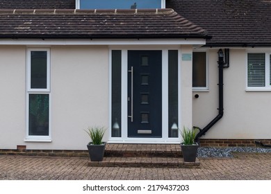 Contemporary Dark Blue Front Door With Small Square Windows With A Planter Either Side