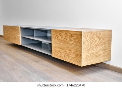 Contemporary floating media cabinet in living room. Wall mounted wooden cabinet
