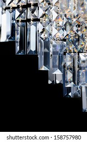 Contemporary glass chandelier fragment isolated over black background