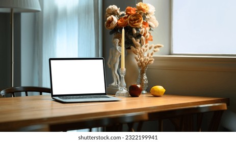 Contemporary home interior with laptop computer, candle holder, beautiful roses in ceramic vase on wooden table - Shutterstock ID 2322199941