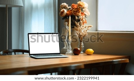 Contemporary home interior with laptop computer, candle holder, beautiful roses in ceramic vase on wooden table 商業照片 © 