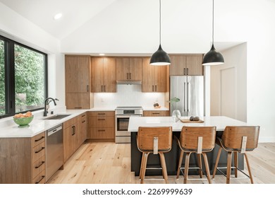 Contemporary home with minimal furnishings and decor light wood floor stairs white walls large windows with black frames and simple style - Powered by Shutterstock