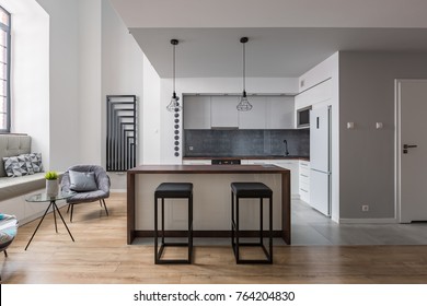 Contemporary Interior With Kitchen Island, Bar Stools And Cozy Window Seat