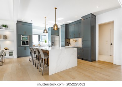 contemporary kitchen spice kitchen with grey cabinets white marble counter top sinks range appliances eating counter and pendant lights - Shutterstock ID 2052298682