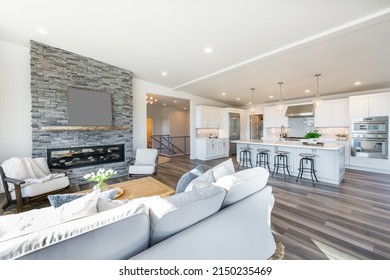 contemporary living room great room with stone fireplace open concept and hardwood floors - Shutterstock ID 2150235469