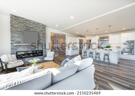 contemporary living room great room with stone fireplace open concept and hardwood floors
