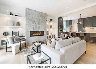 contemporary living room with open concept view through to dining room kitchen and a marble fireplace with gas fire - Shutterstock ID 2052298703