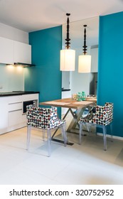 Contemporary mini kitchen with table sets. / Modern small kitchen interior.