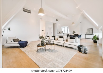 Contemporary minimalist interior design of lounge zone with couches and carpet in attic open space apartment with white walls and loft style - Shutterstock ID 1978726499