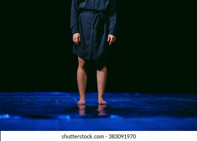 A contemporary and modern dancer stays without shoes in the middle of the scene ready for performance - Shutterstock ID 383091970