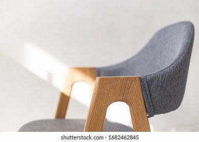 Contemporary Modern Kitchen Armchair With Wooden Furniture Legs. Close Up View With Soft Focus