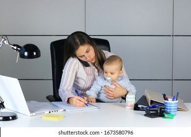 Contemporary mother working from home while looking after her baby - Powered by Shutterstock