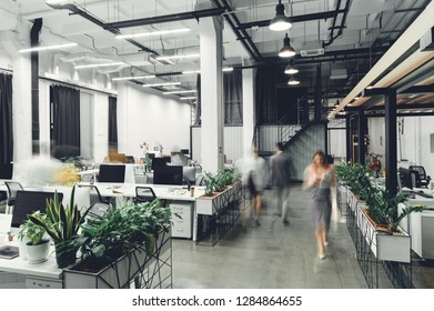 contemporary office interior with blurred business people in motion 