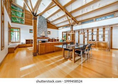 Contemporary Pacific Northwest home living room and dining room with high vaulted ceilings wood beams - Powered by Shutterstock