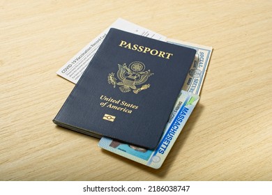Contemporary Personal Identification Information set of passport Social Security Real ID and COVID-19 Vaccination card all lying on wooden tabletop. - Shutterstock ID 2186038747