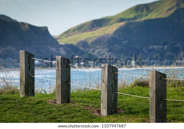 Contemporary post and cable public\
fence design around hilltop scenic lookout, above Wainui, Okitu,\
and Makorori Beaches. East Coast, North Island, New Zealand \
