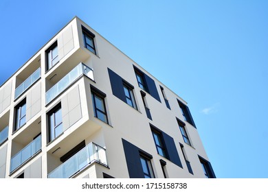Contemporary residential building exterior in the daylight. Modern apartment buildings on a sunny day with a blue sky. Facade of a modern apartment building - Shutterstock ID 1715158738