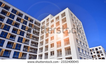 Contemporary residential building exterior in the daylight. Modern apartment buildings on a sunny day with a blue sky. Facade of a modern apartment building. 