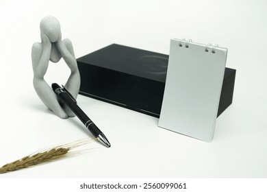 Contemporary smartphone and complementary items, including a charging adapter, USB cable, pen, and notebook, arranged on a minimalistic white surface.