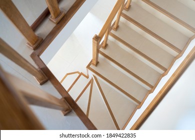 Contemporary stairway with wood handrail. Interior stairs. Staircase going down. Pathway of stairway or staircase inside a house. Interior structure design concept.