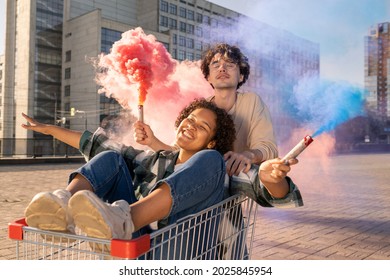 Contemporary teens with firecrackers having fun against urban environment