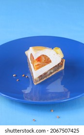 Contemporary Tropical Fruit Multi-Layered Mousse Tart On Blue Background.