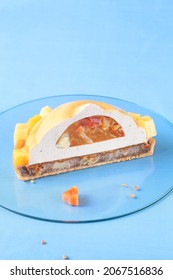 Contemporary Tropical Fruit Multi-Layered Mousse Tart On Blue Background.