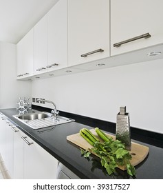 Contemporary White Kitchen With Black Granite Worktop