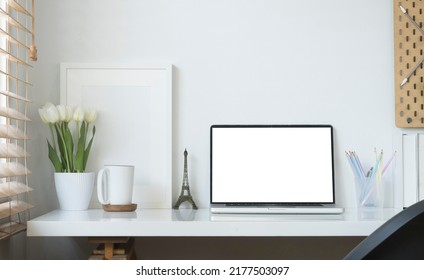 Contemporary workplace with laptop computer, picture frame, stationery and flower pot. Blank screen for your advertise text. - Shutterstock ID 2177503097