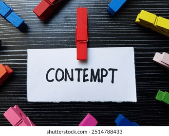 Contempt writting on table background.