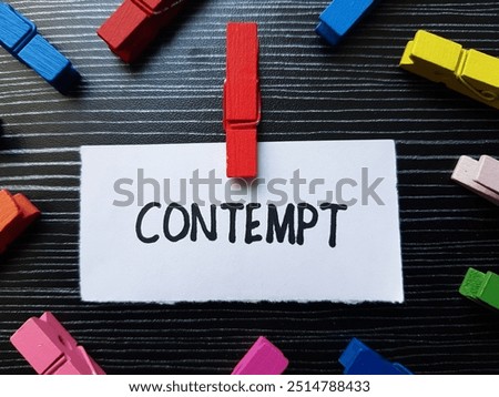 Contempt writting on table background.