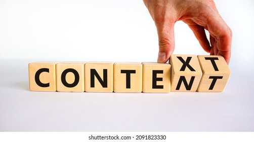Content and context symbol. Businessman turns wooden cubes and changes the word context to content. Beautiful white table, white background. Business and content and context concept. Copy space.